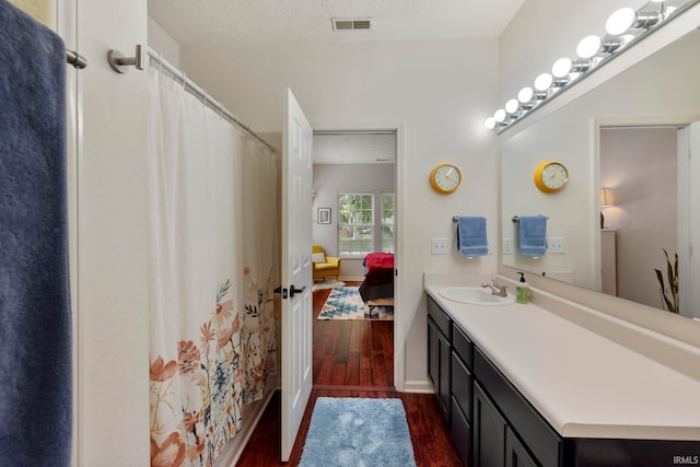 1009 Elliott St, Lafayette, IN 47905 - bathroom featuring wood finished floors, vanity, and ensuite bathroom