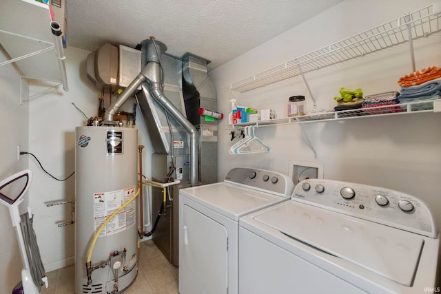 1009 Elliott St, Lafayette, IN 47905 - laundry area with gas water heater, washer and clothes dryer, light tile patterned flooring, and a textured ceiling