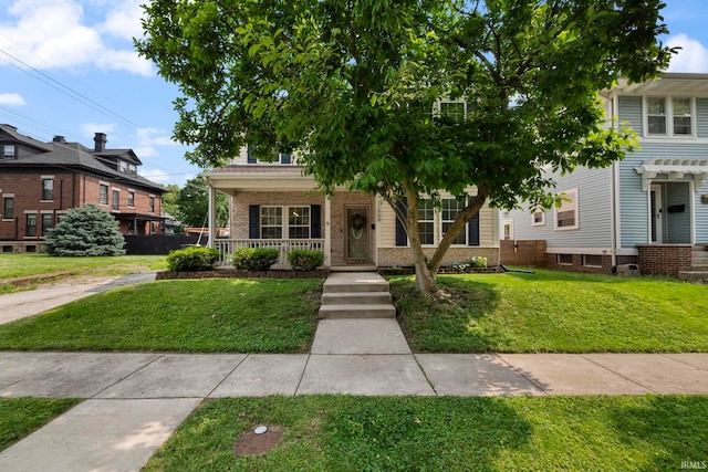 1009 Elliott St, Lafayette, IN 47905 - view of front facade featuring a porch, brick siding, and a front yard