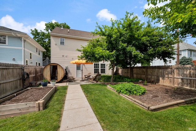 1009 Elliott St, Lafayette, IN 47905 - rear view of property with a garden, a fenced backyard, and a patio area