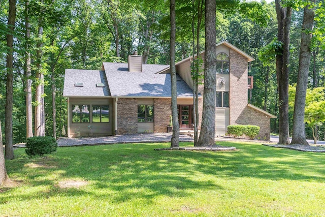 5549 S Tammany Ct, Bloomington, IN 47401 - mid-century home with a chimney, a front yard, a shingled roof, and brick siding