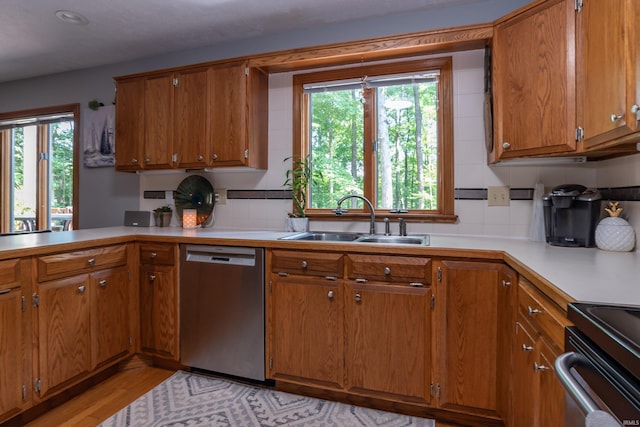 5549 S Tammany Ct, Bloomington, IN 47401 - kitchen with stainless steel dishwasher, brown cabinets, plenty of natural light, light countertops, and recessed lighting