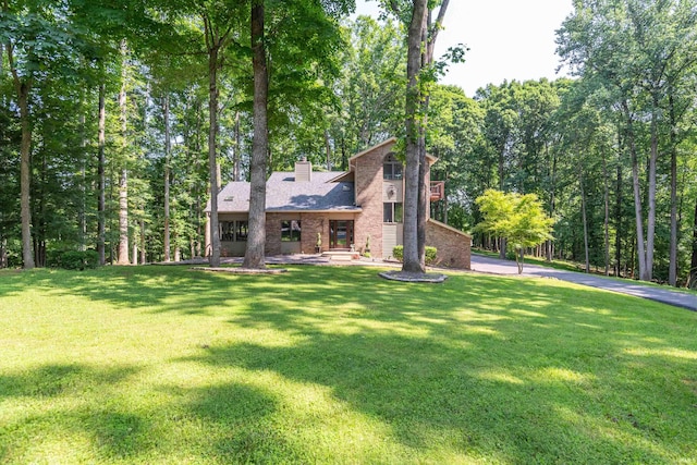 5549 S Tammany Ct, Bloomington, IN 47401 - view of front of home with a front lawn, a chimney, and brick siding