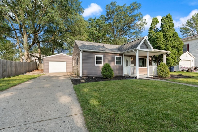 425 S Harding St, Warsaw, IN 46580 - view of front of house featuring covered porch, an outbuilding, driveway, a detached garage, and a shingled roof
