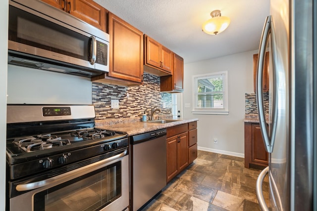 425 S Harding St, Warsaw, IN 46580 - kitchen featuring stainless steel appliances, backsplash, brown cabinetry, and dark stone finish flooring