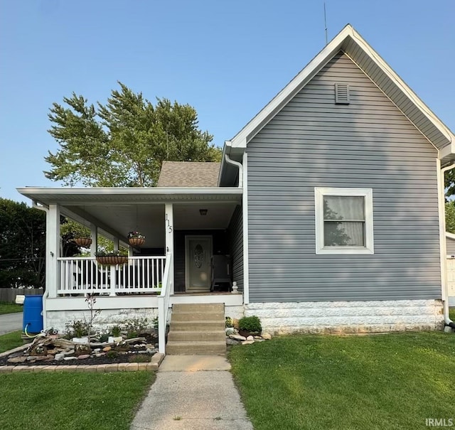 115 N Posey St, Windfall, IN 46076 - view of front of house with a porch, a front yard, and roof with shingles