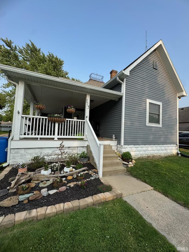 115 N Posey St, Windfall, IN 46076 - view of front of home featuring covered porch and a chimney