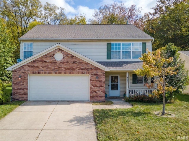 4103 Stergen Dr, Lafayette, IN 47909 - traditional home featuring driveway, brick siding, a front yard, a garage, and a porch