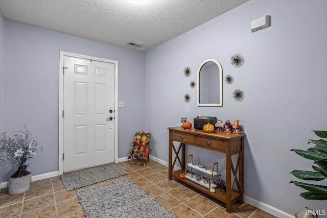 4103 Stergen Dr, Lafayette, IN 47909 - foyer featuring a textured ceiling and tile patterned flooring