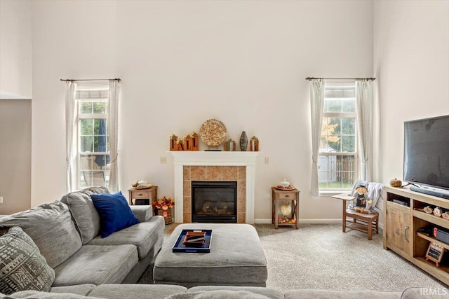 4103 Stergen Dr, Lafayette, IN 47909 - carpeted living room featuring a high ceiling and a tiled fireplace
