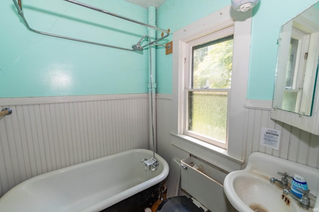 302 C St, Laporte, IN 46350 - bathroom featuring a freestanding tub and a wainscoted wall