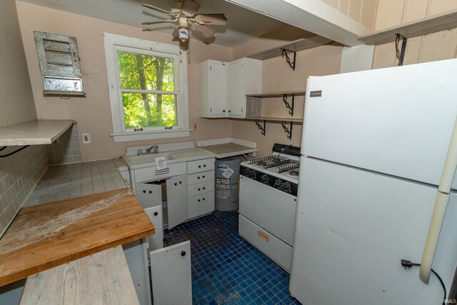 302 C St, Laporte, IN 46350 - kitchen with white appliances, a ceiling fan, white cabinetry, open shelves, and dark tile patterned flooring