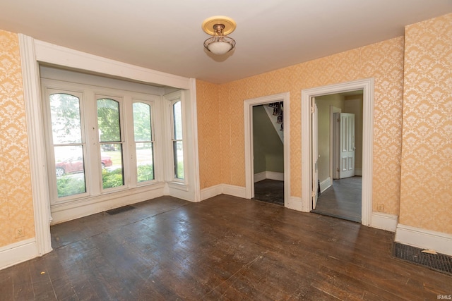 302 C St, Laporte, IN 46350 - spare room with dark wood-style floors and wallpapered walls