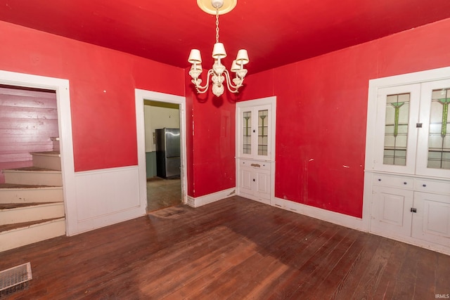 302 C St, Laporte, IN 46350 - unfurnished dining area with a chandelier, wood finished floors, and stairway