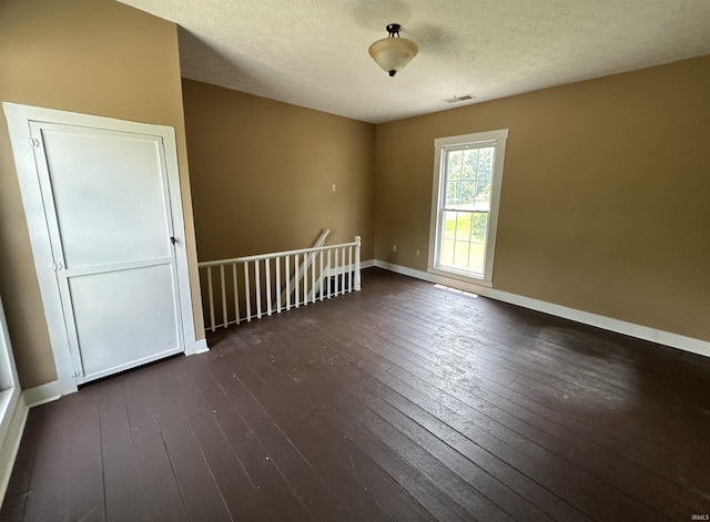 709 W Main St, Ellettsville, IN 47429 - spare room featuring dark wood-style flooring and a textured ceiling