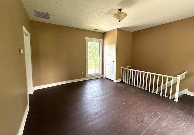709 W Main St, Ellettsville, IN 47429 - empty room featuring dark wood-type flooring and a textured ceiling