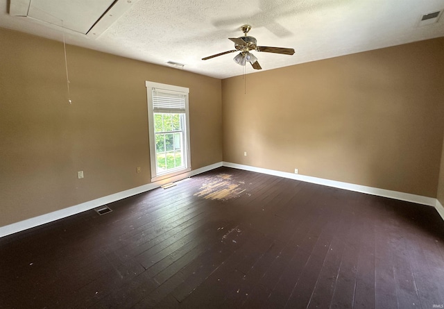 709 W Main St, Ellettsville, IN 47429 - spare room featuring attic access, dark wood-style flooring, and ceiling fan