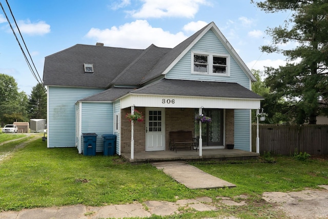 306 W Mcconnell St, Oxford, IN 47971 - view of front of home featuring covered porch, brick siding, and roof with shingles