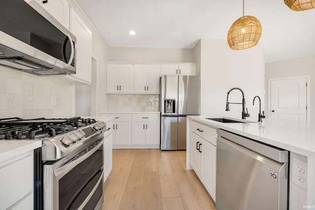 17464 Sonic Ct, Huntertown, IN 46748 - kitchen featuring appliances with stainless steel finishes, light countertops, tasteful backsplash, white cabinets, and recessed lighting