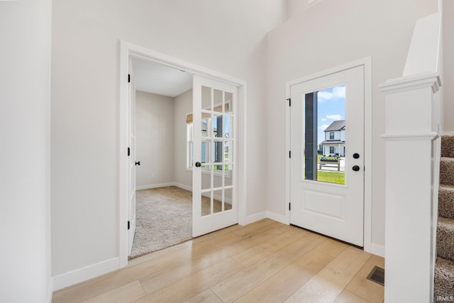 17464 Sonic Ct, Huntertown, IN 46748 - entrance foyer with light wood finished floors, plenty of natural light, and stairs