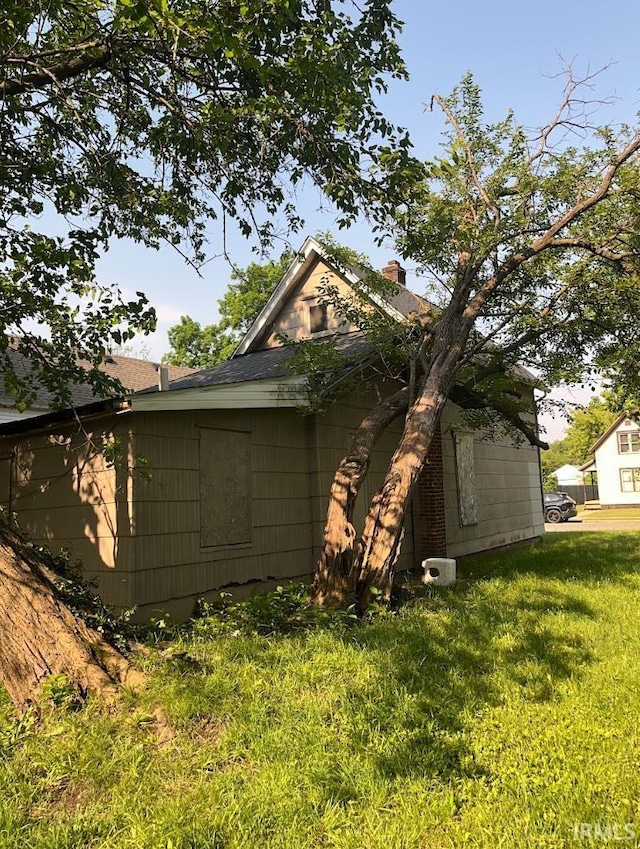 816 Allen St, South Bend, IN 46616 - view of property exterior with a lawn, a chimney, and a shingled roof