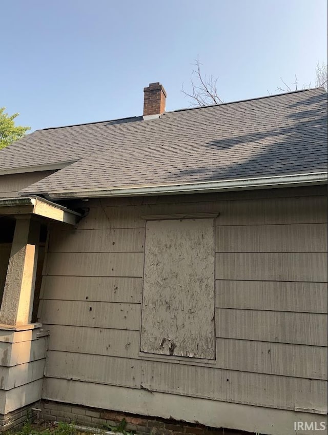 816 Allen St, South Bend, IN 46616 - exterior view of roof with shingles and a chimney