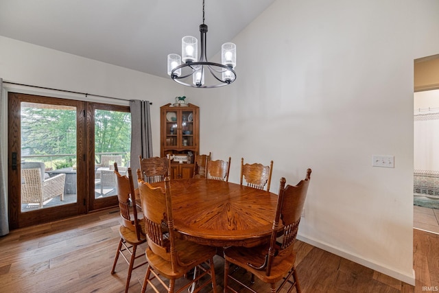 502 N Jefferson Ave, Fowler, IN 47944 - dining area featuring a chandelier, vaulted ceiling, and light wood-style floors