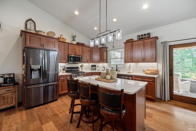 502 N Jefferson Ave, Fowler, IN 47944 - kitchen with appliances with stainless steel finishes, light wood finished floors, decorative backsplash, vaulted ceiling, and recessed lighting