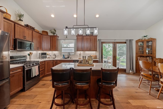 502 N Jefferson Ave, Fowler, IN 47944 - kitchen with stainless steel appliances, backsplash, a breakfast bar area, a center island, and light countertops