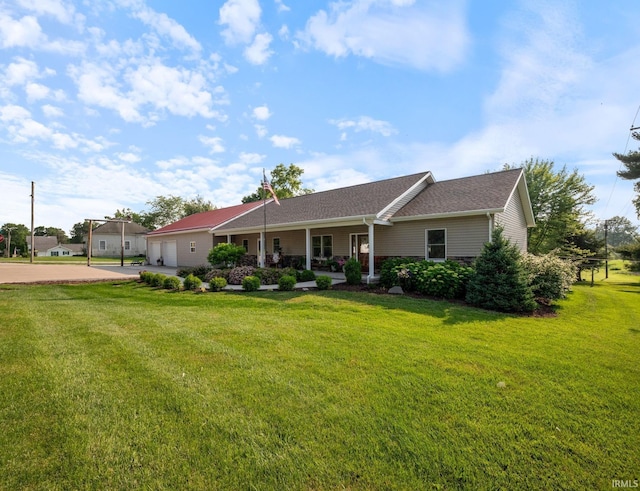 502 N Jefferson Ave, Fowler, IN 47944 - ranch-style home featuring a garage, concrete driveway, a front lawn, covered porch, and roof with shingles