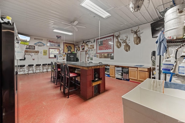 502 N Jefferson Ave, Fowler, IN 47944 - bar area featuring wine cooler, a ceiling fan, and dark aggregate flooring