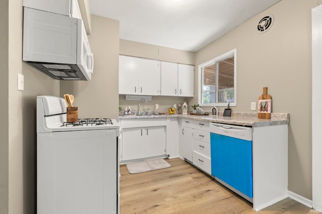 6031 S Calhoun St, Fort Wayne, IN 46803 - kitchen with white appliances, light wood-style floors, light countertops, and white cabinets