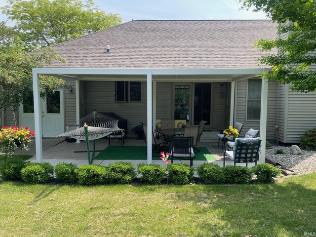12344 Diamond Dr, Plymouth, IN 46563 - back of house with roof with shingles, a patio area, and a yard