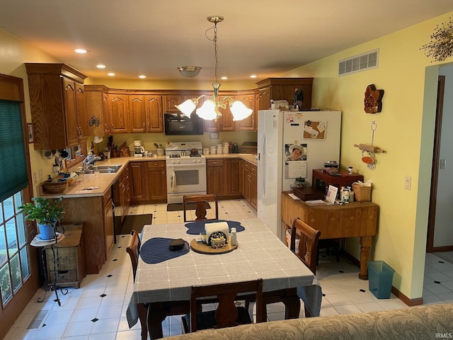 12344 Diamond Dr, Plymouth, IN 46563 - kitchen with white appliances, a chandelier, light tile patterned floors, hanging light fixtures, and recessed lighting