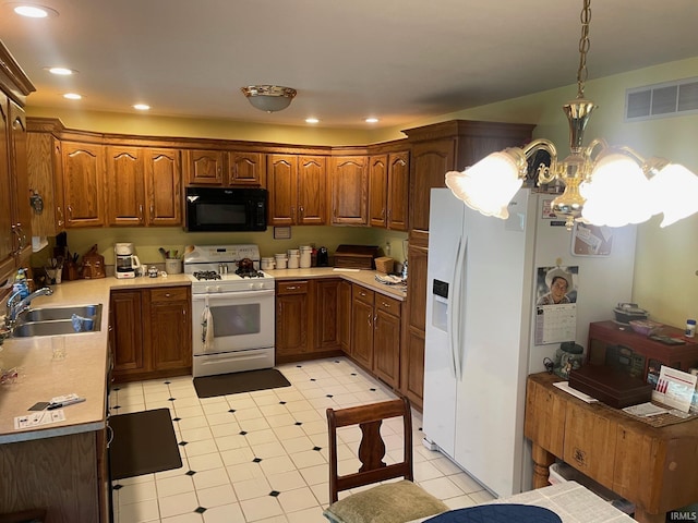 12344 Diamond Dr, Plymouth, IN 46563 - kitchen with white appliances, a chandelier, light countertops, brown cabinetry, and recessed lighting