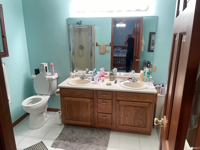 12344 Diamond Dr, Plymouth, IN 46563 - ensuite bathroom featuring a shower stall, double vanity, and tile patterned floors