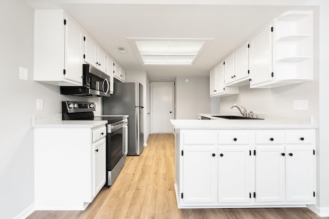 7104 Thamesford Dr Unit 83, Fort Wayne, IN 46835 - kitchen with appliances with stainless steel finishes, white cabinetry, light countertops, light wood finished floors, and open shelves