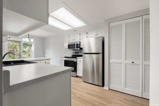 7104 Thamesford Dr Unit 83, Fort Wayne, IN 46835 - kitchen featuring stainless steel appliances, white cabinetry, light wood finished floors, and light countertops
