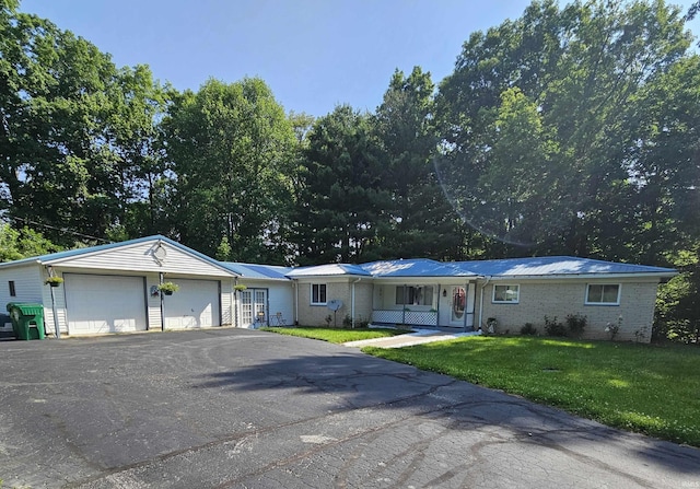 989 S Cataract Rd, Spencer, IN 47460 - single story home with a front lawn, a metal roof, a detached garage, and brick siding