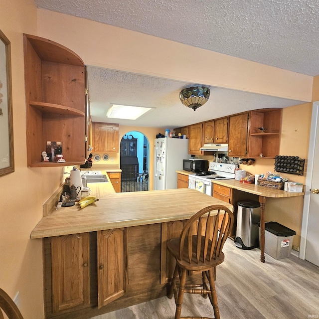 989 S Cataract Rd, Spencer, IN 47460 - kitchen featuring open shelves, white appliances, under cabinet range hood, a textured ceiling, and a peninsula
