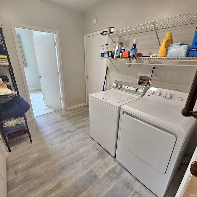 989 S Cataract Rd, Spencer, IN 47460 - laundry area with washing machine and dryer and light wood-style floors