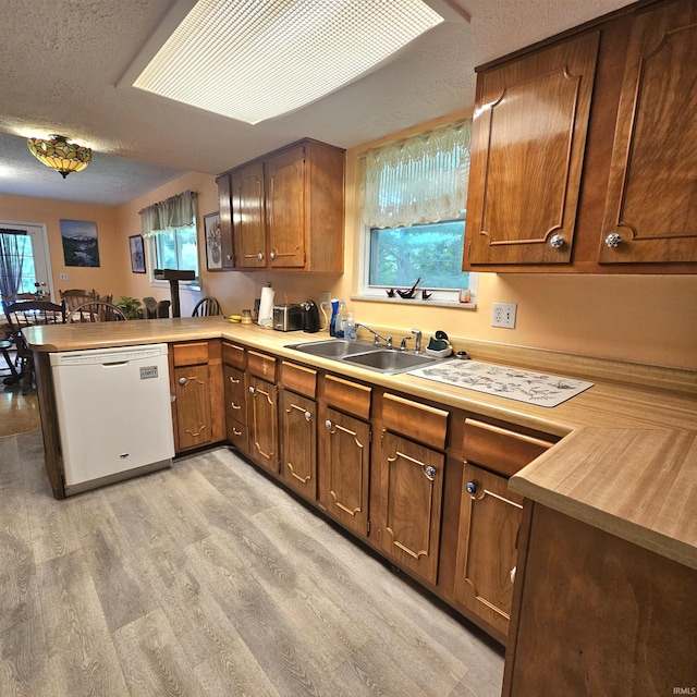 989 S Cataract Rd, Spencer, IN 47460 - kitchen featuring dishwasher, light wood finished floors, light countertops, a peninsula, and a textured ceiling