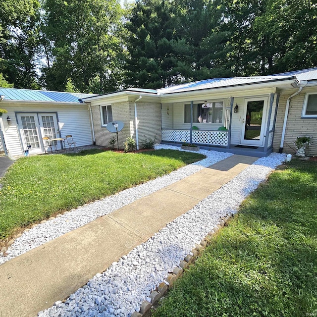 989 S Cataract Rd, Spencer, IN 47460 - ranch-style home with a front lawn, a metal roof, brick siding, french doors, and a porch