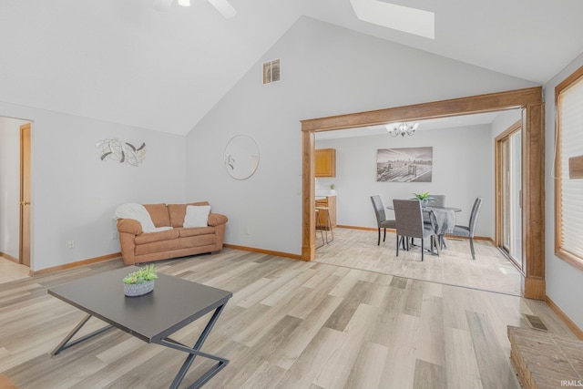 2319 Autumn Lake Pl, Fort Wayne, IN 46818 - living area featuring light wood-style flooring, a chandelier, a skylight, high vaulted ceiling, and ceiling fan