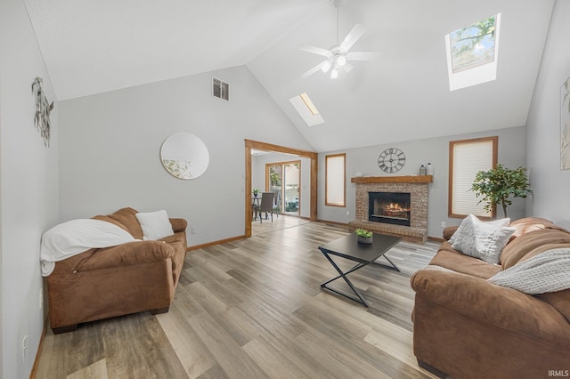 2319 Autumn Lake Pl, Fort Wayne, IN 46818 - living room with a skylight, high vaulted ceiling, a ceiling fan, light wood finished floors, and a fireplace