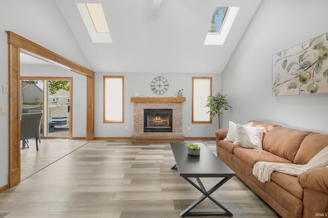 2319 Autumn Lake Pl, Fort Wayne, IN 46818 - living area with a skylight, high vaulted ceiling, a brick fireplace, and light wood-style flooring