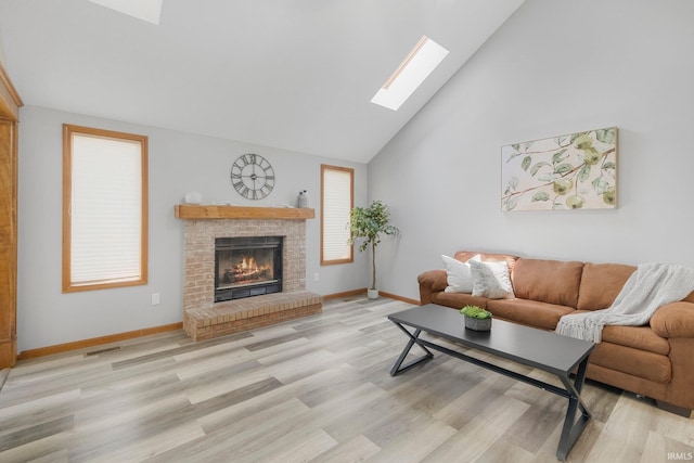 2319 Autumn Lake Pl, Fort Wayne, IN 46818 - living area with a skylight, high vaulted ceiling, light wood-style floors, and a brick fireplace