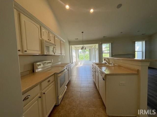 3239 S Parnel Ct, Bloomington, IN 47403 - kitchen with white appliances, plenty of natural light, light countertops, white cabinetry, and recessed lighting