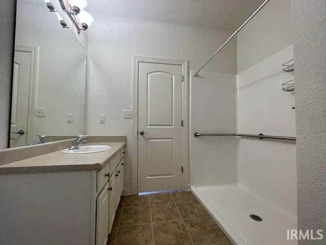 3239 S Parnel Ct, Bloomington, IN 47403 - bathroom with vanity, a shower, and tile patterned floors