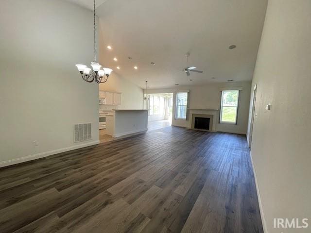 3239 S Parnel Ct, Bloomington, IN 47403 - unfurnished living room with high vaulted ceiling, a ceiling fan, dark wood-style floors, a fireplace, and a chandelier